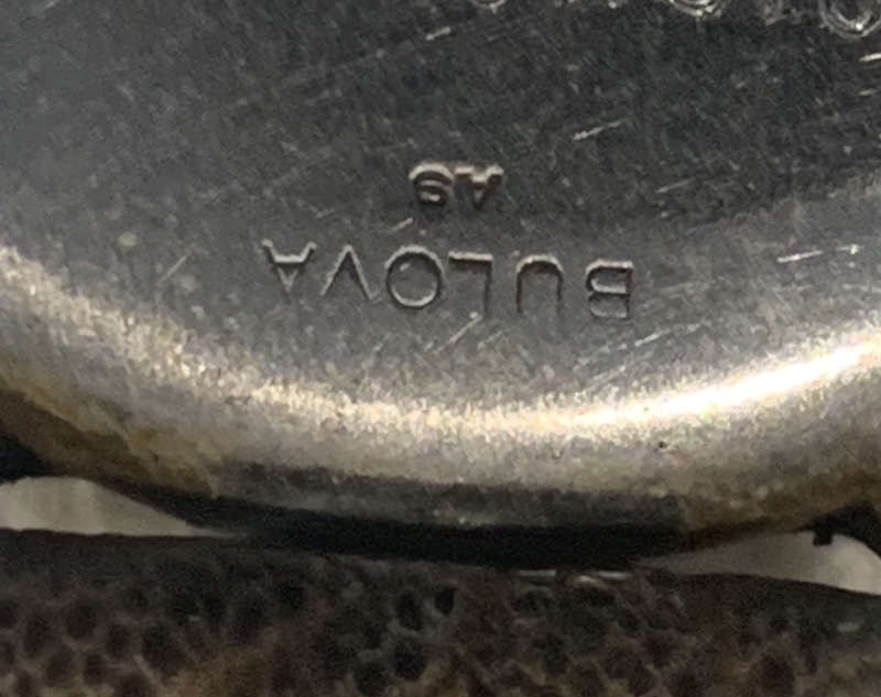 Back of watch with two stamps on it. Appears to be A9 but not sure.