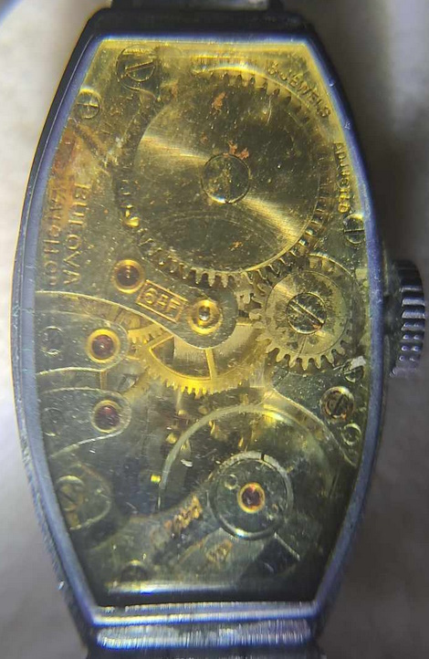 Gold-tone movement with engravings including "Bulova Watch Co.", "USA", "Fifteen 15 Jewels", "Adjusted", "6AF", and  lastly "RS", and "AF" at the regulator.